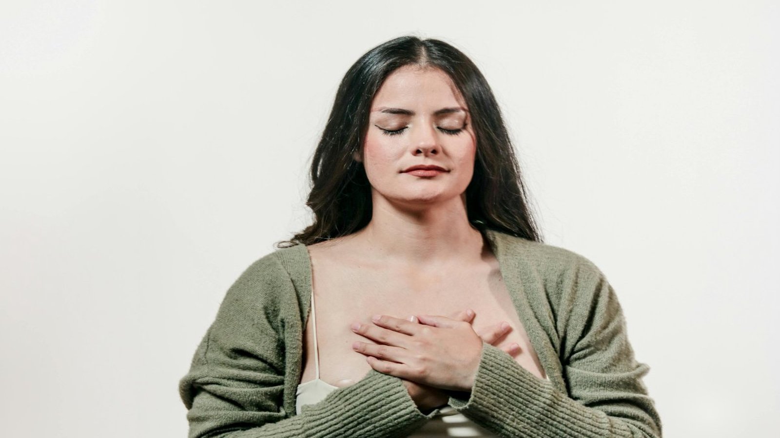 Woman with hands on chest — therapy for feeling stuck Denver