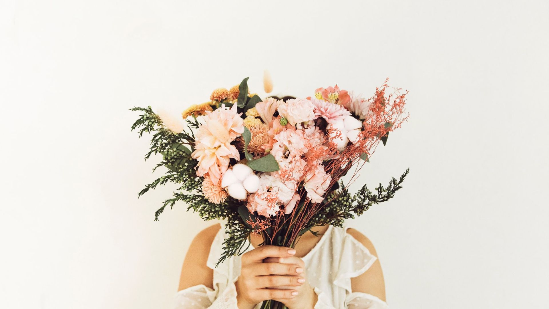 Woman holding pink bouquet representing the Full Bloom Counseling blog on mental health in Denver Colorado