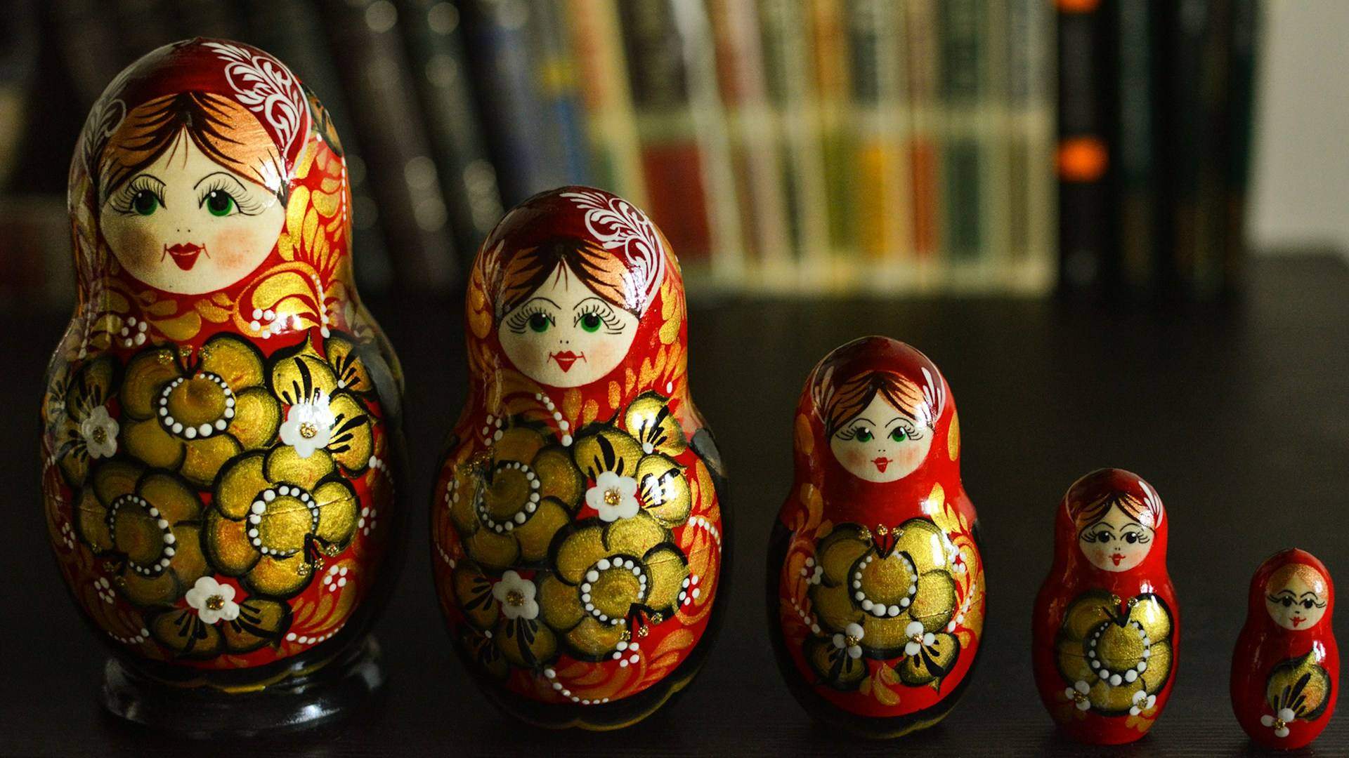 Row of painted nesting dolls, one inside another, like the parts of a person