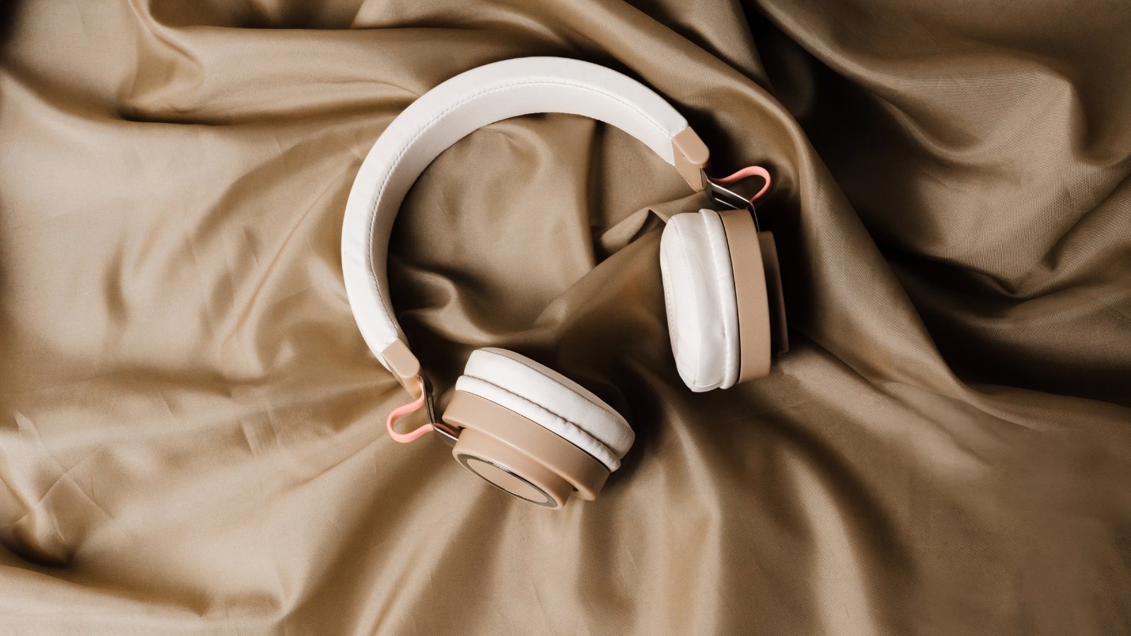 Headphones on gold fabric — Safe and Sound Protocol therapy Denver