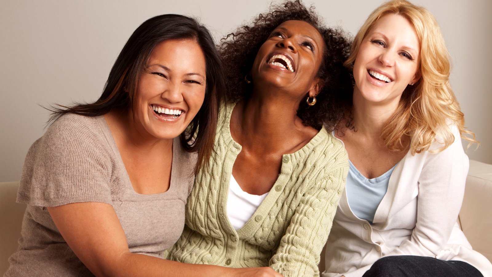 Three diverse women laughing — therapy for women Denver Colorado